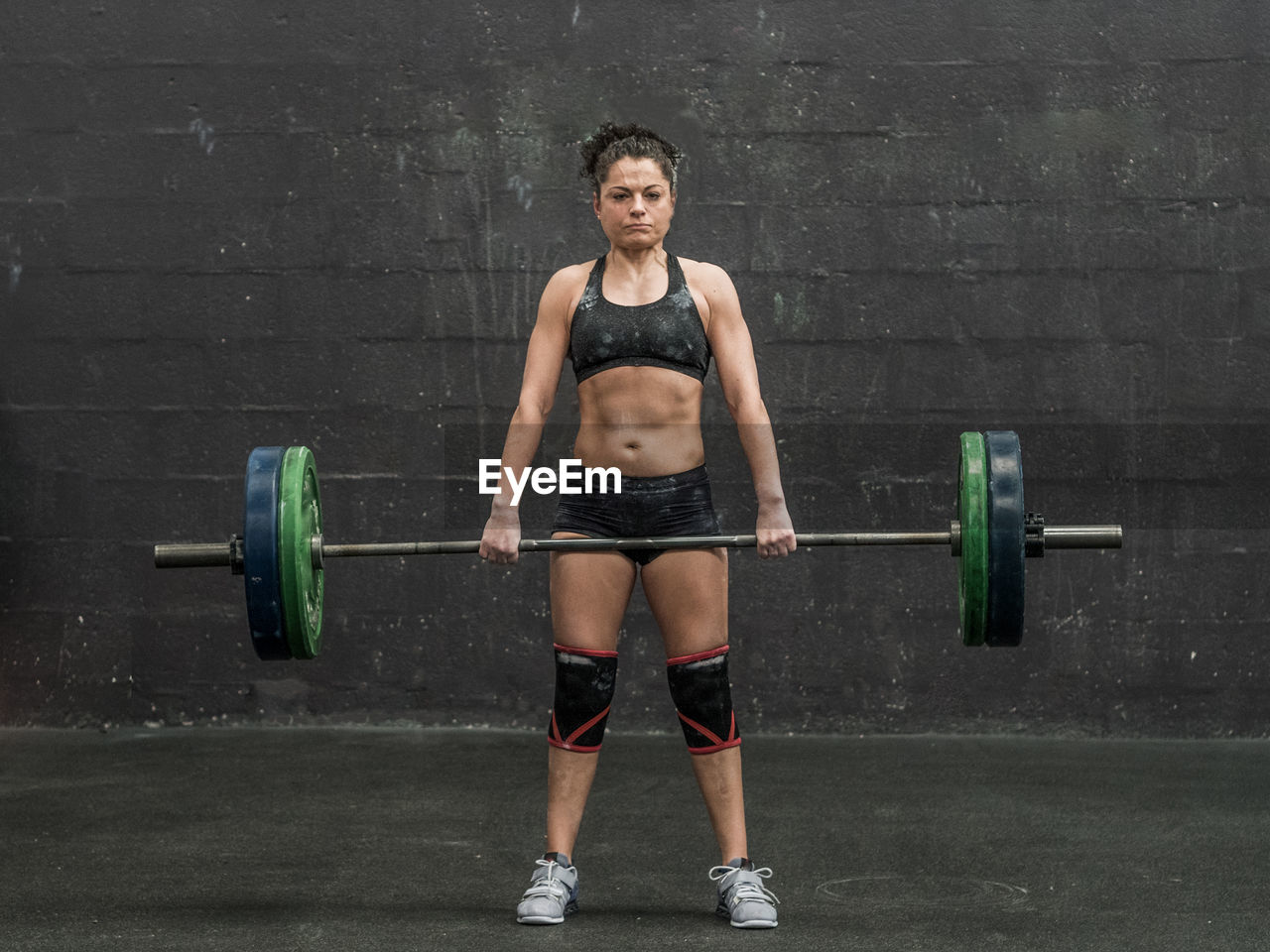 Full length of woman doing deadlift
