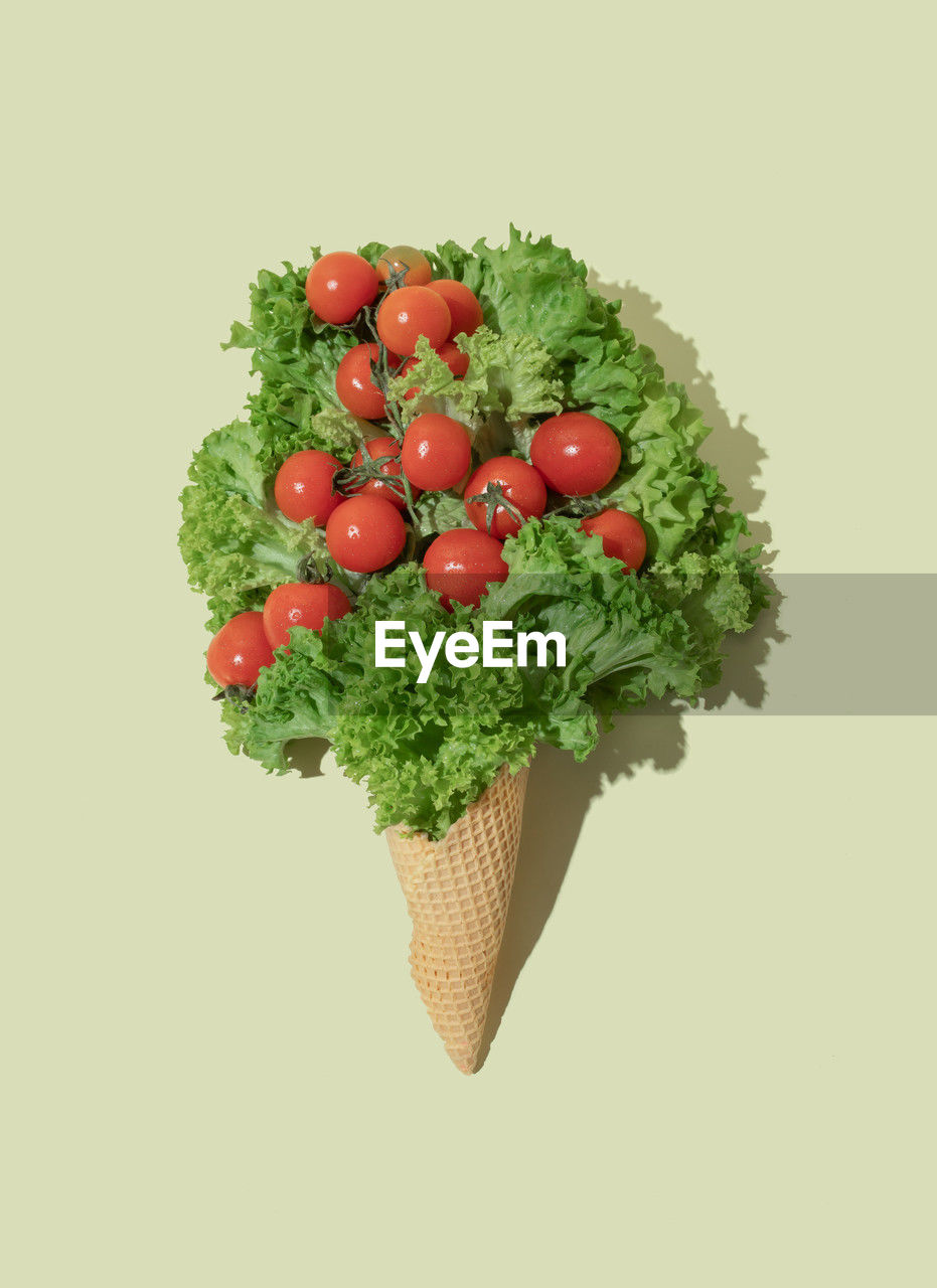 Ice cream cone with lettuce and cherry tomatoes. flat lay. nature summer concept.