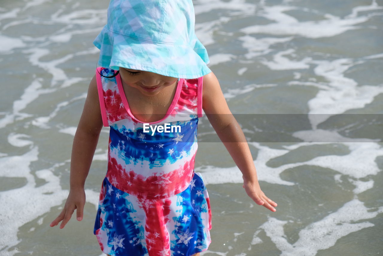 Full length of girl playing in beach