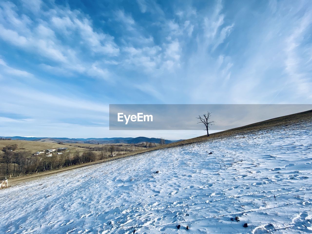 Snow covered land road against sky