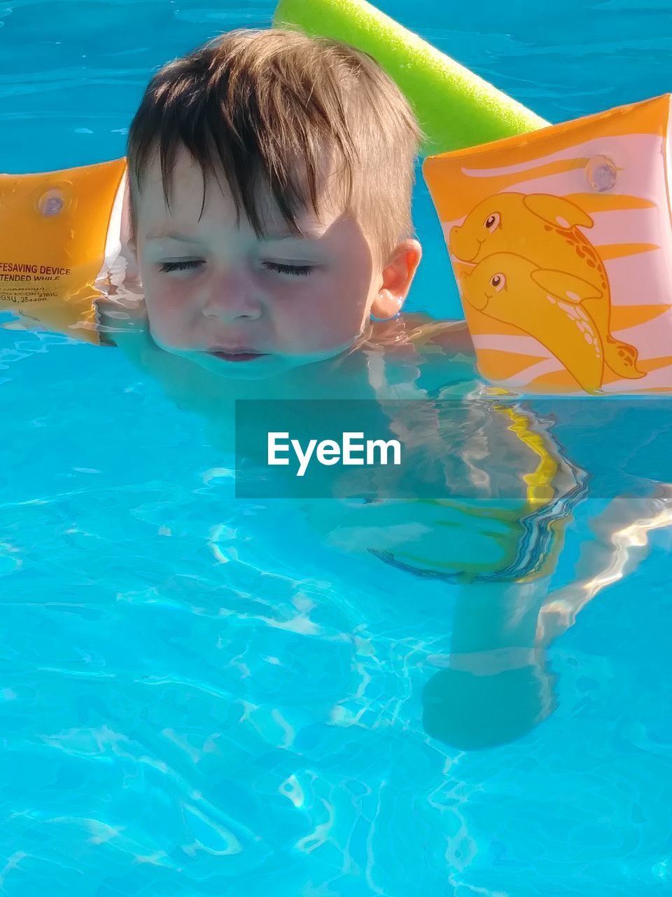 Cute boy swimming in pool