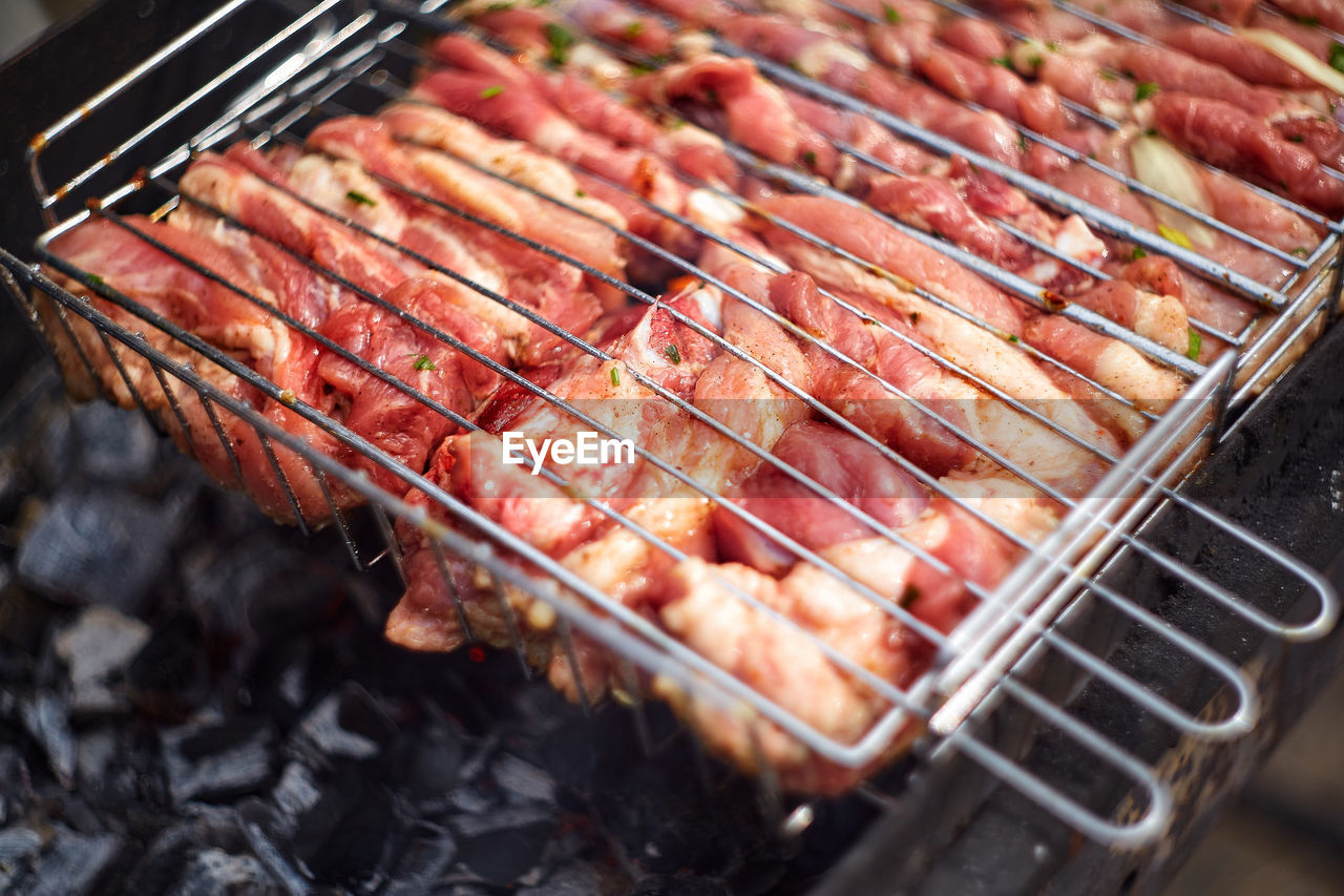 HIGH ANGLE VIEW OF MEAT ON BARBECUE
