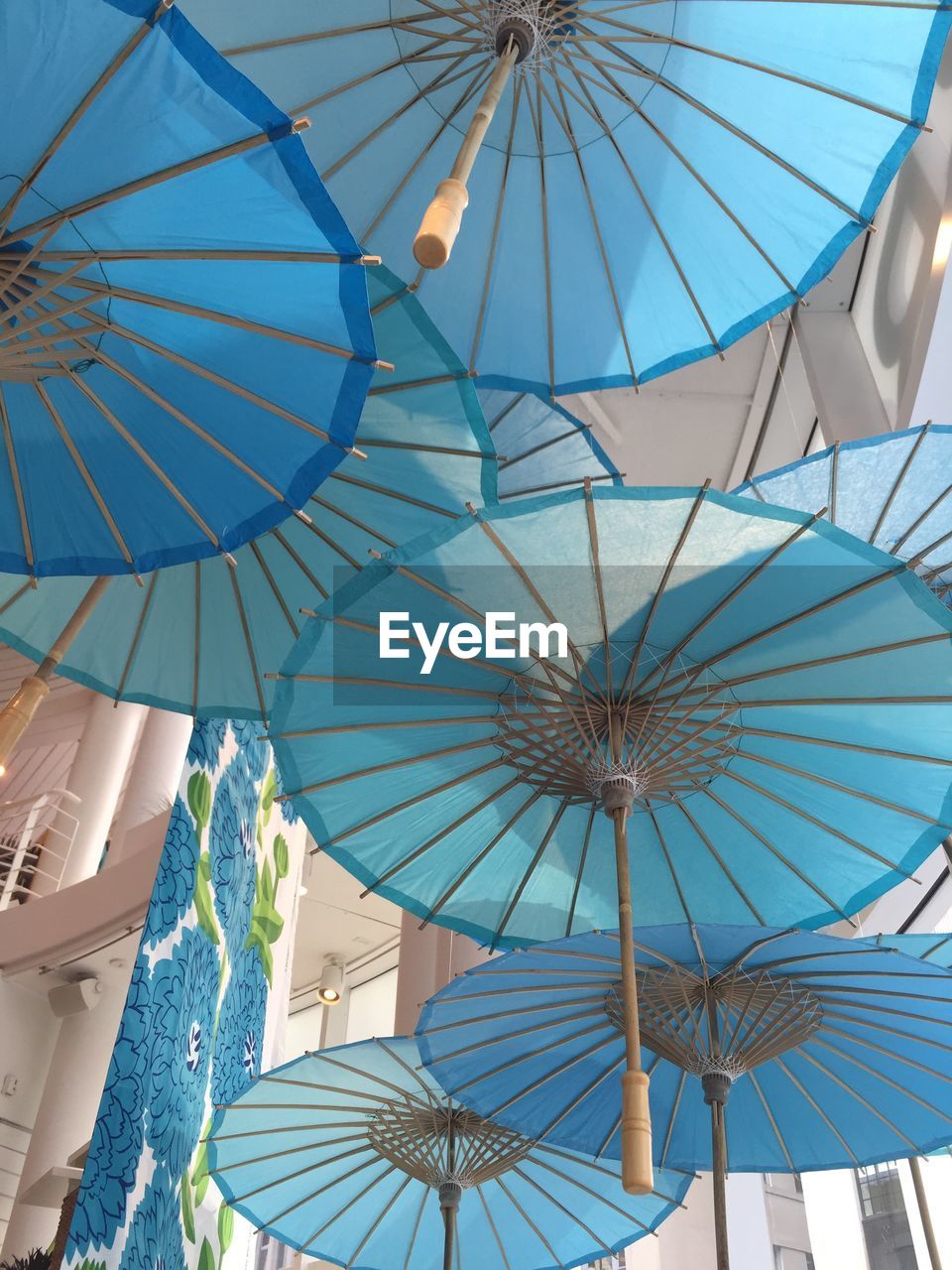 LOW ANGLE VIEW OF UMBRELLAS HANGING