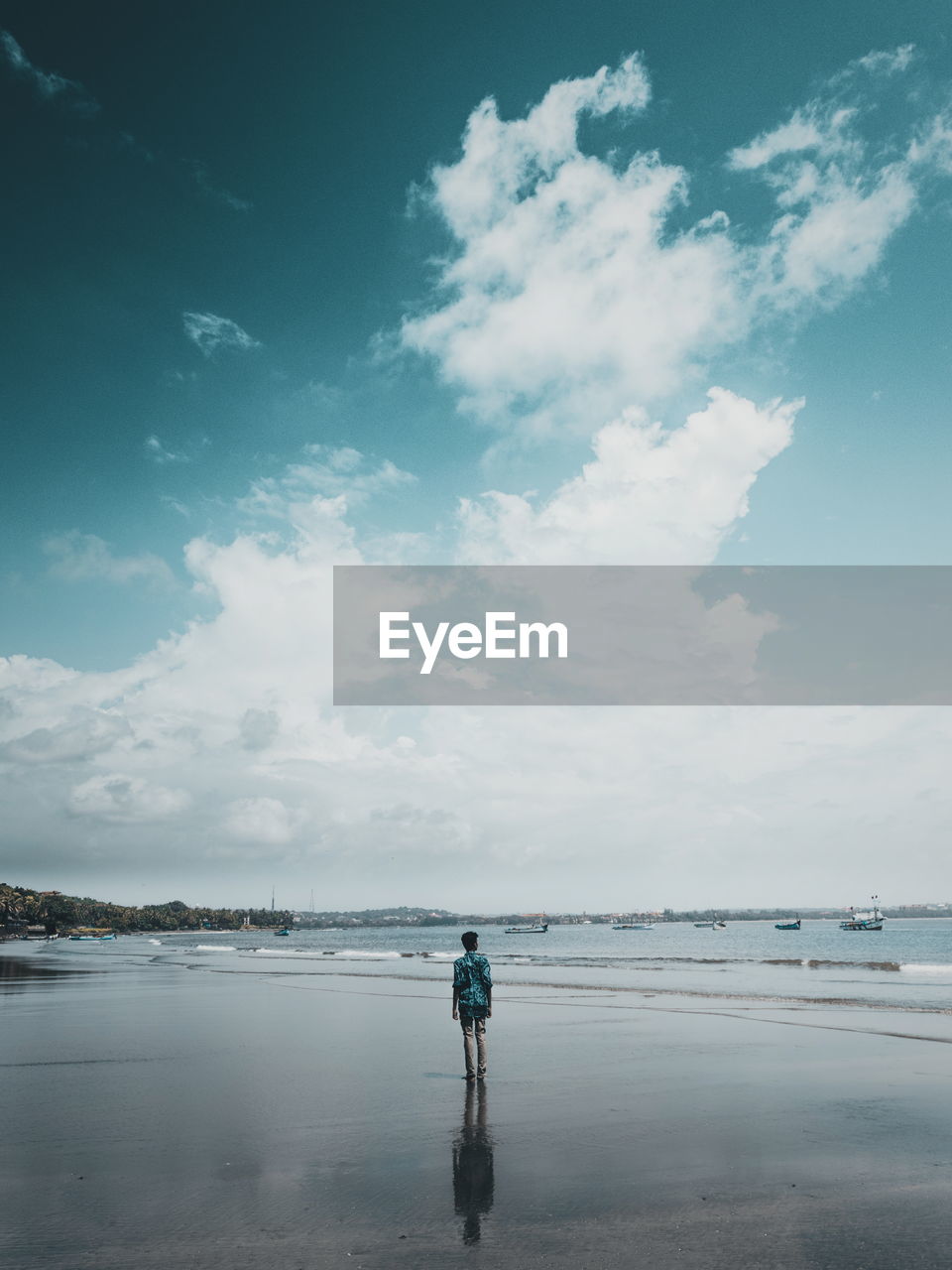 Man standing on beach against sky