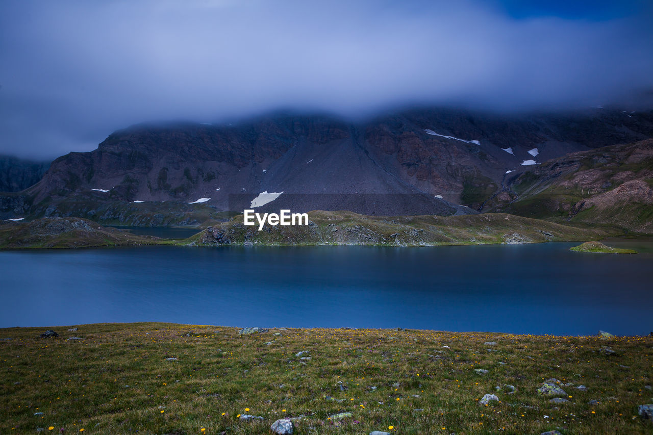 Scenic view of lake against mountains at gran paradiso national park