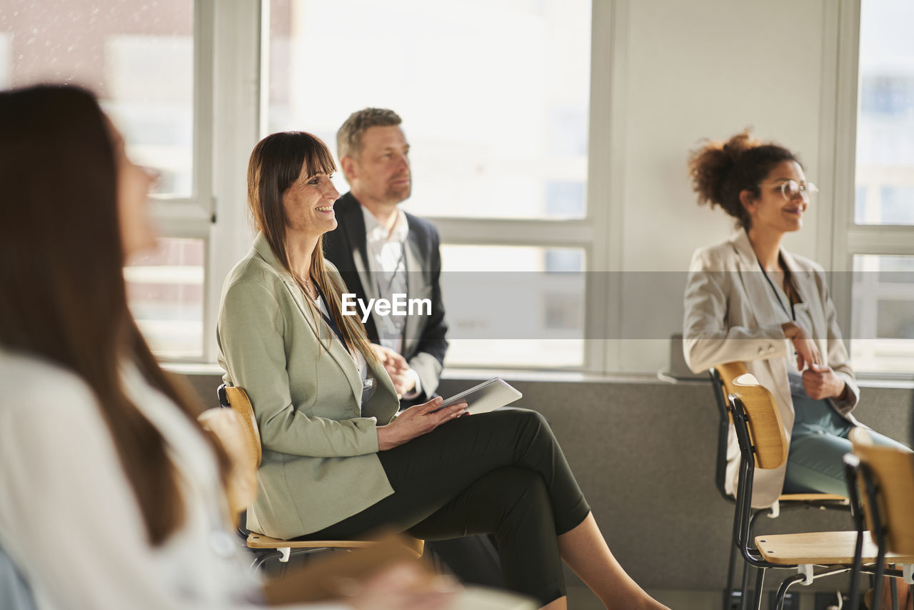 Entrepreneurs attending training class in conference centre at office