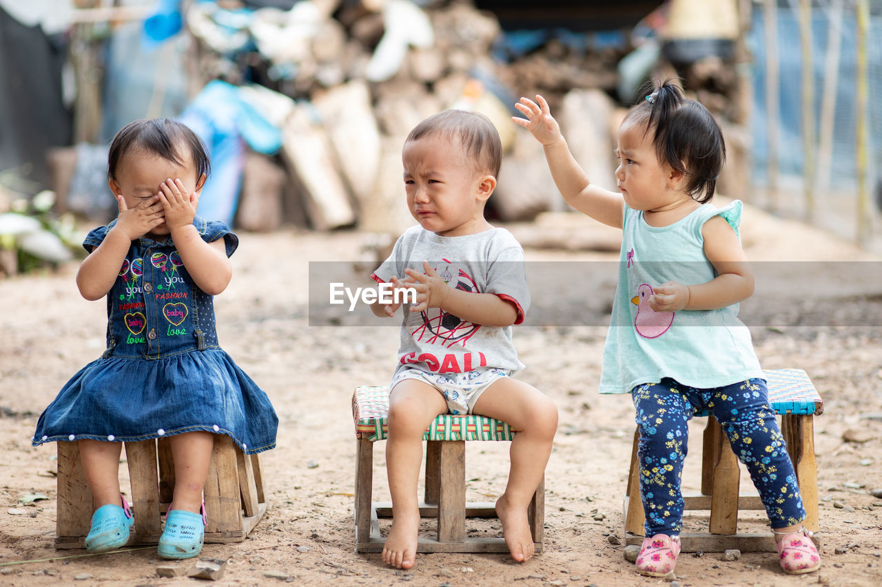 FULL LENGTH OF CHILDREN SITTING ON PEOPLE