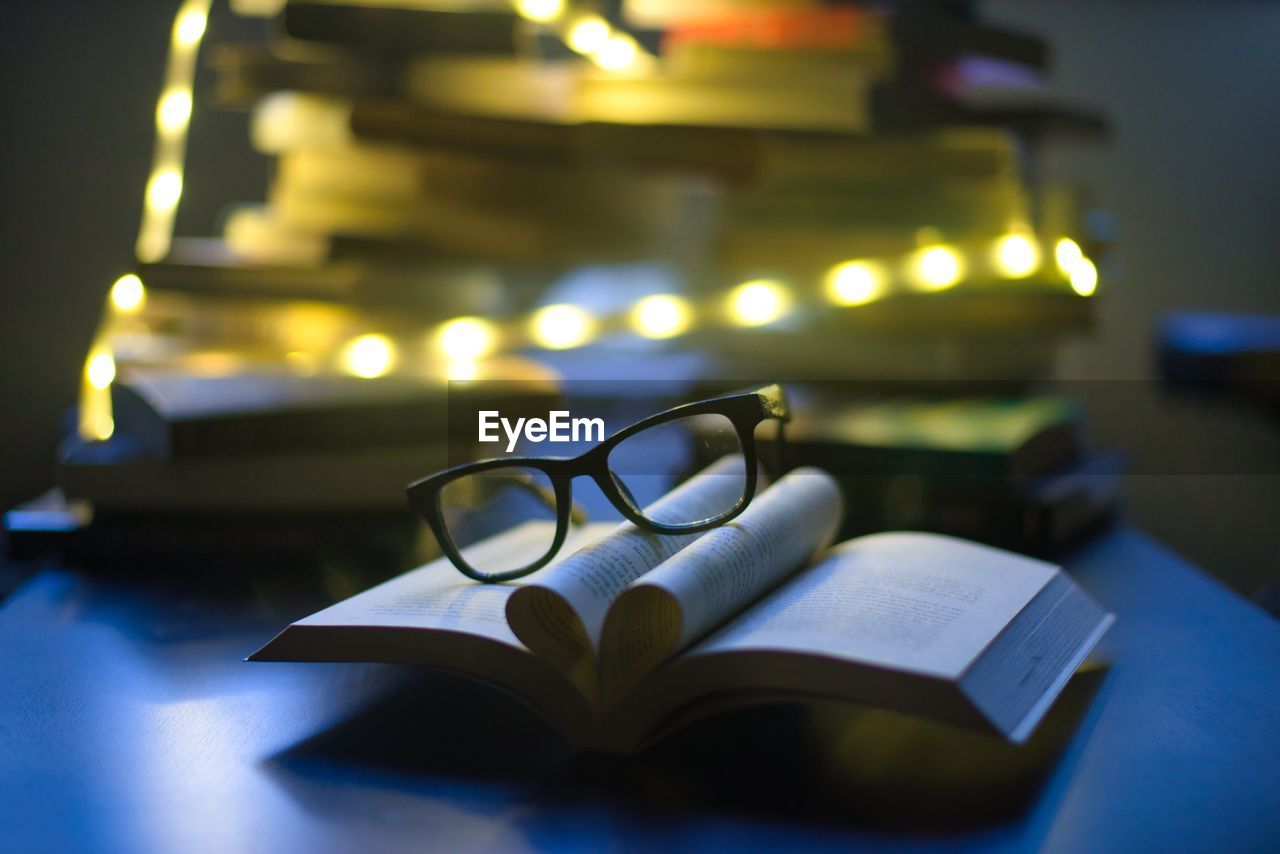 Close-up of eyeglasses on books on table