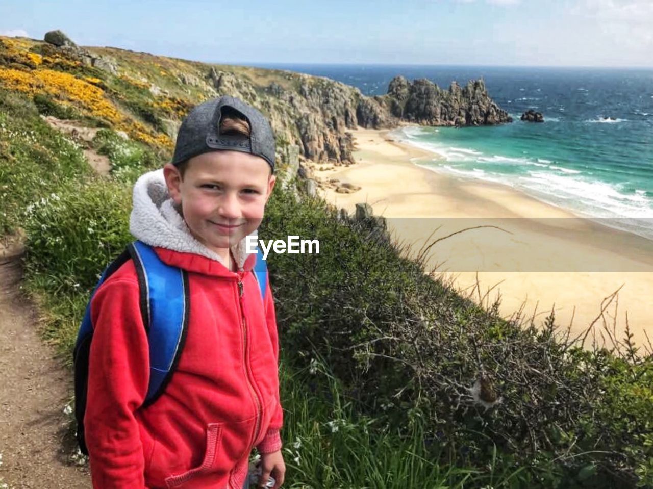 Portrait of smiling boy standing at beach