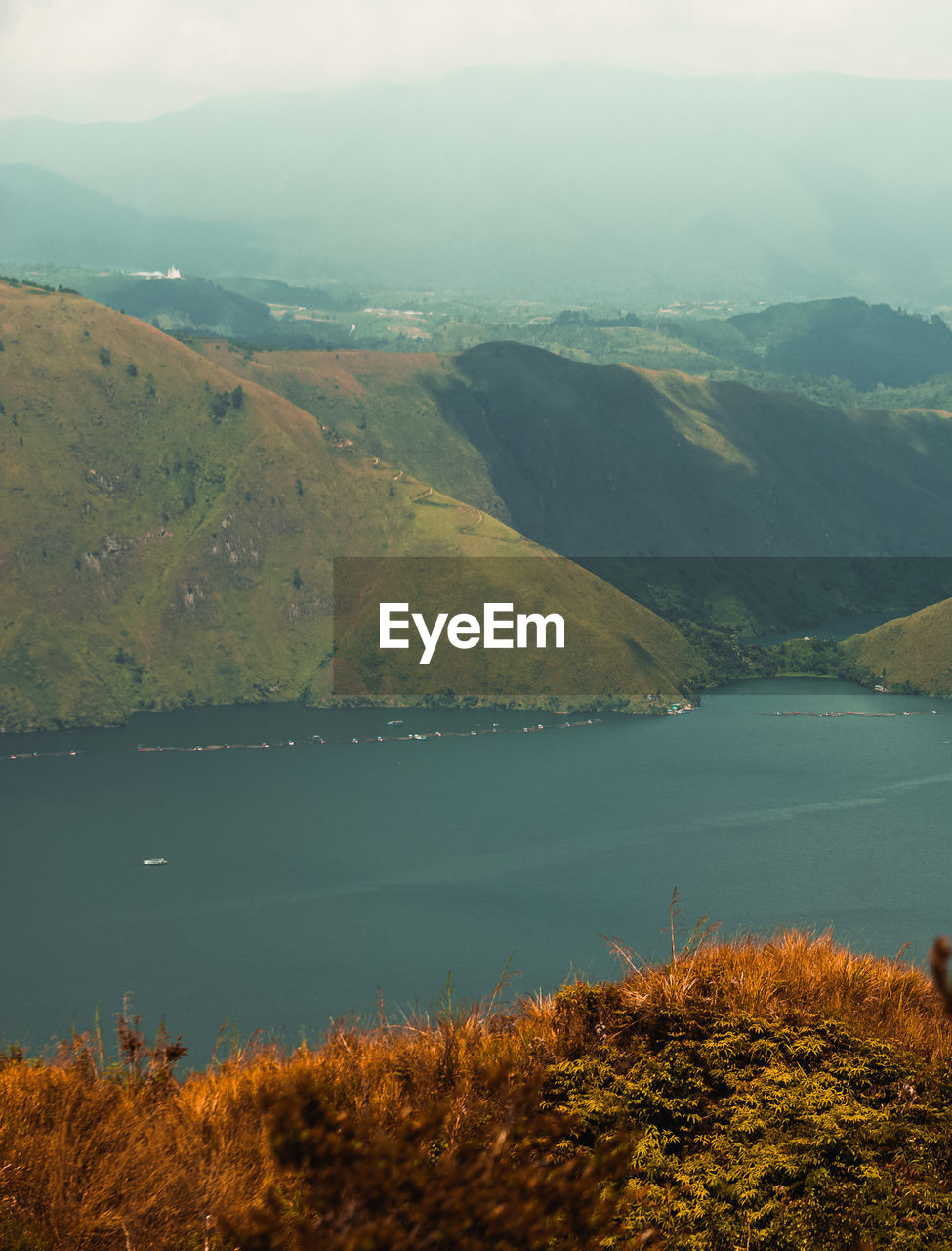 Scenic view of lake and mountains against sky