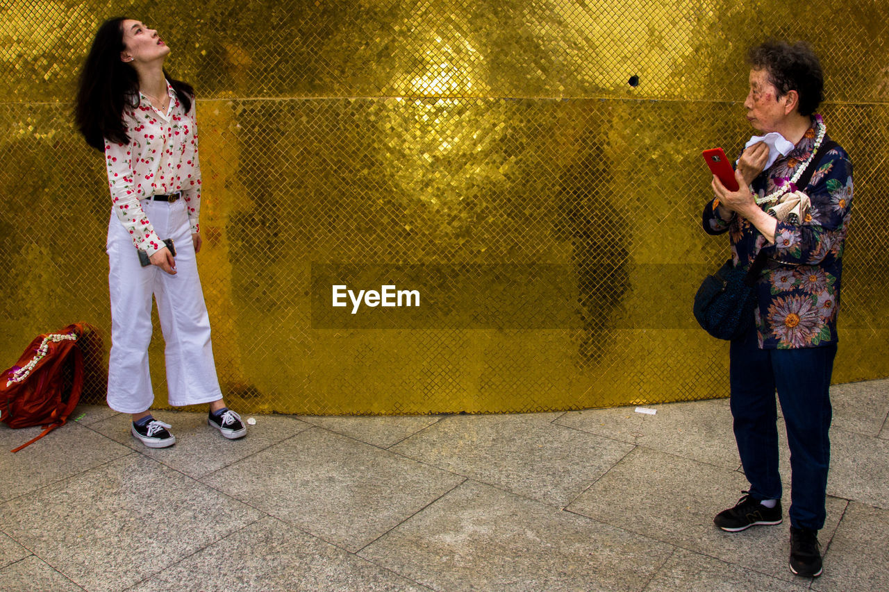 COUPLE STANDING ON SIDEWALK