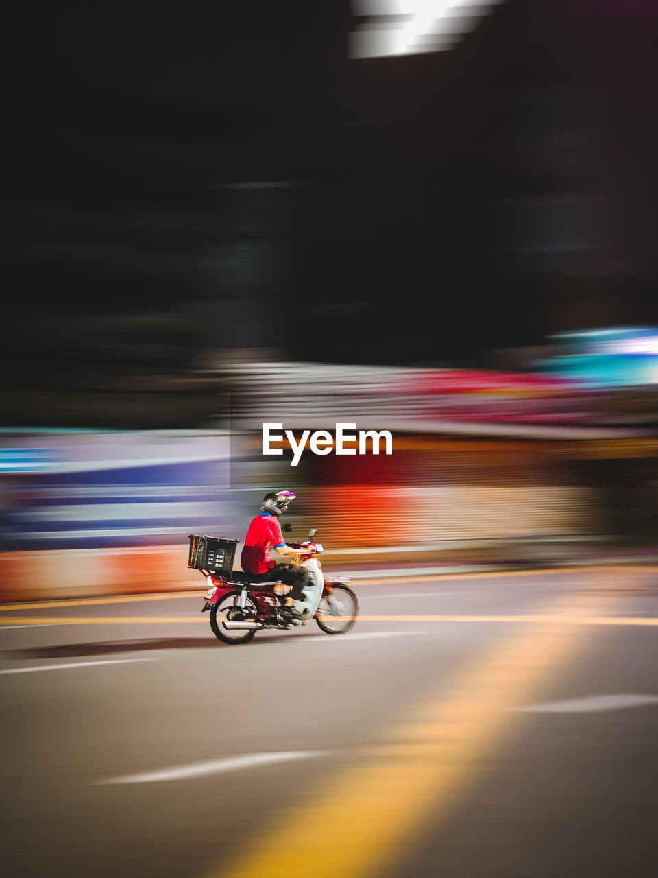 Blurred motion of man riding motorcycle