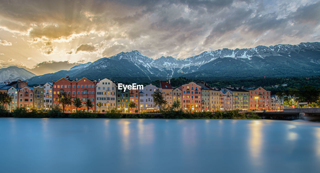 Scenic view of lake by buildings against sky