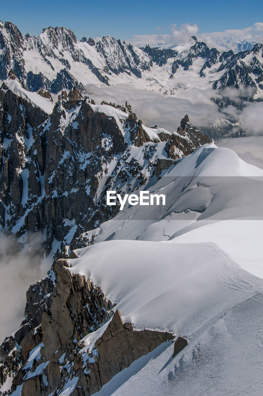 Snowy peaks and mountains in a sunny day, viewed from the aiguille du midi, near chamonix, france.