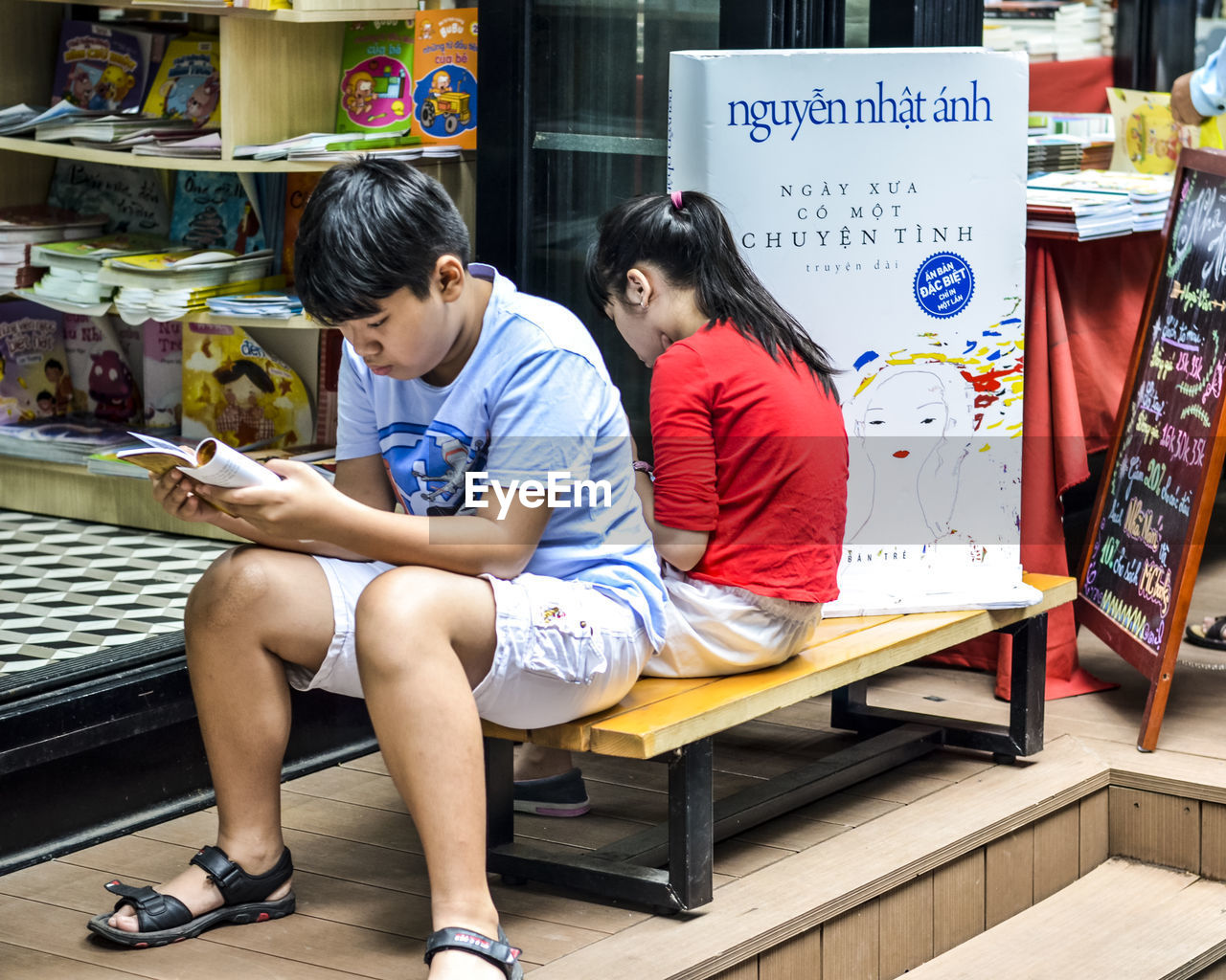 HIGH ANGLE VIEW OF TWO PEOPLE SITTING ON LAPTOP