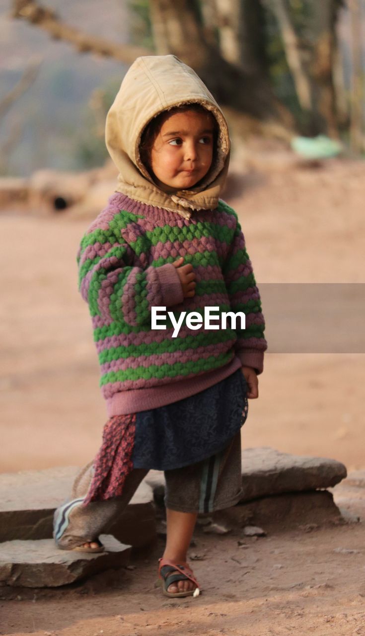 Portrait of girl wearing hat standing outdoors