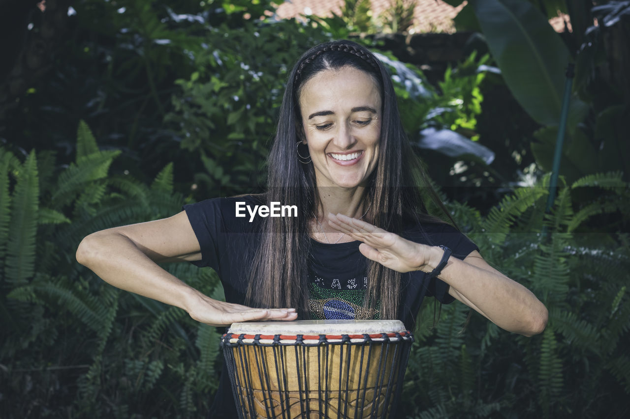 Woman playing the bongo drums 