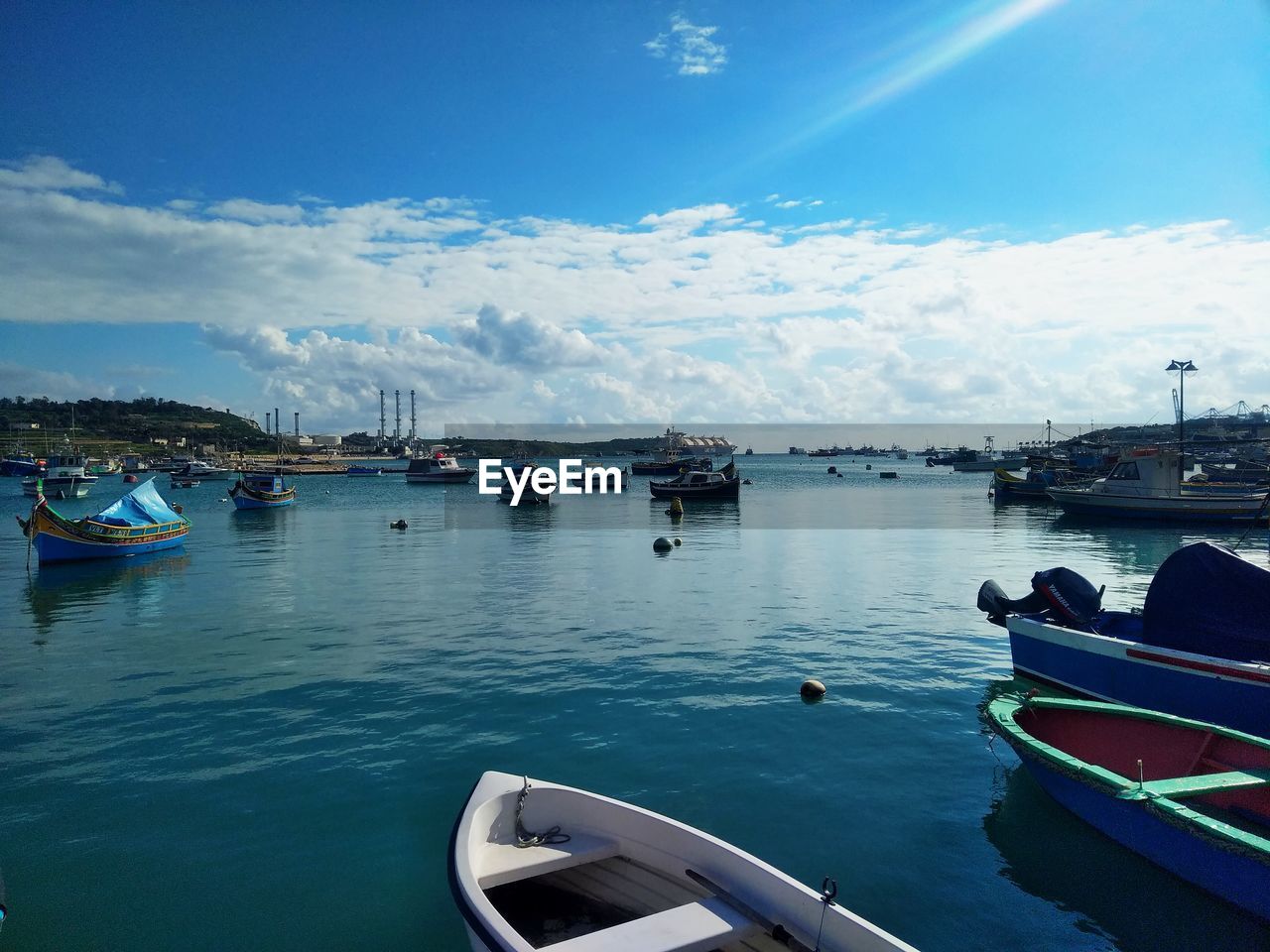 SAILBOATS MOORED IN SEA