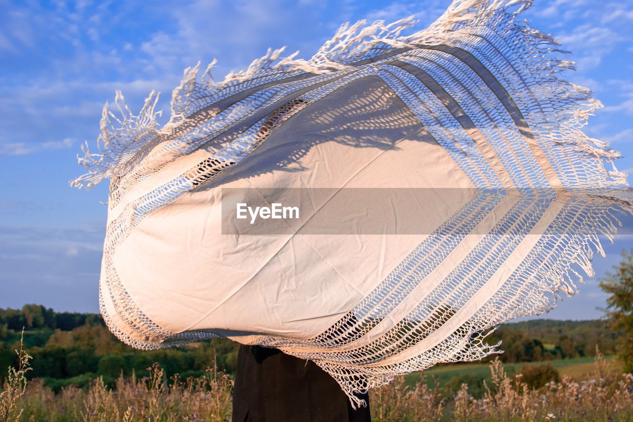 An image of a flying tablecloth on field against sky