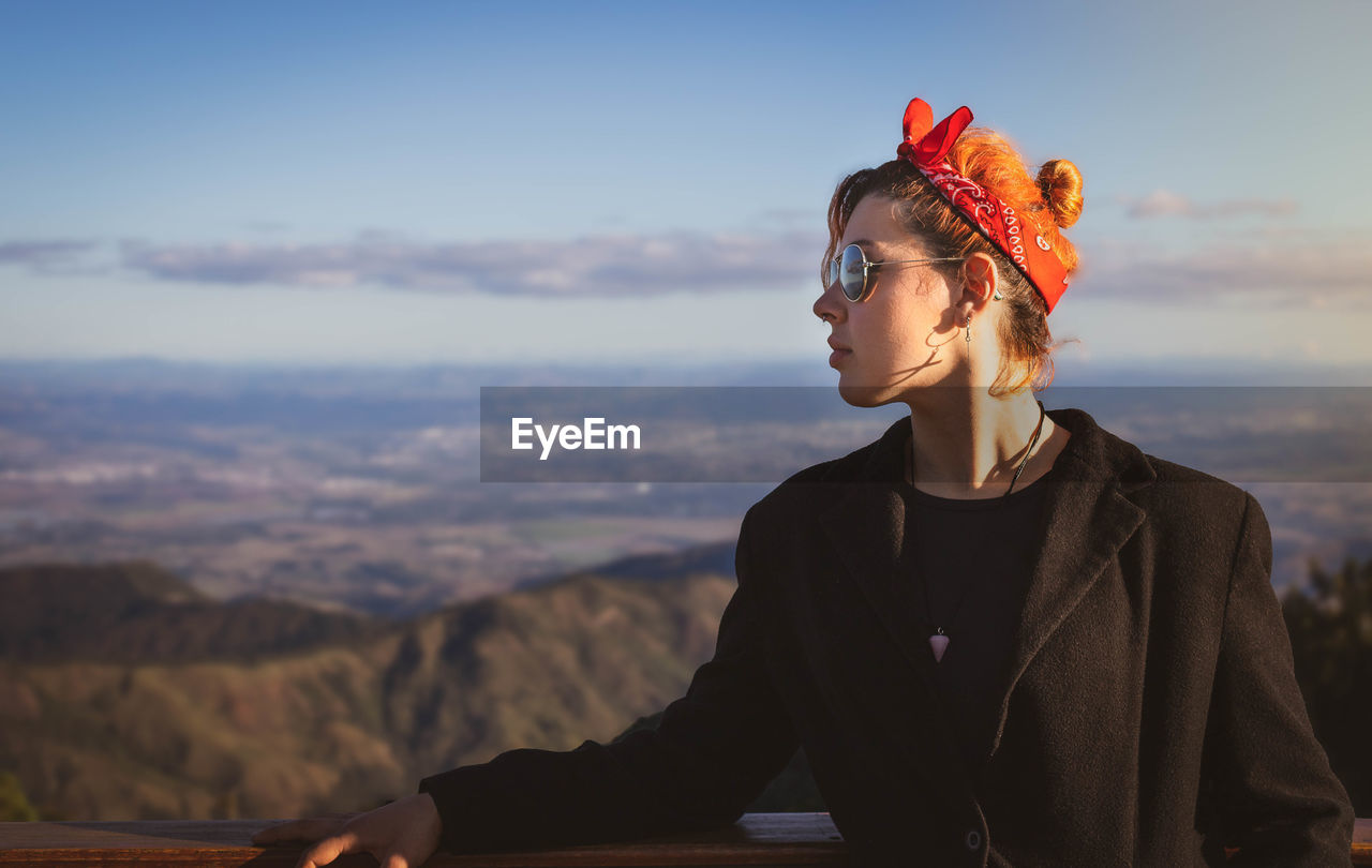 Man looking at mountains against sky