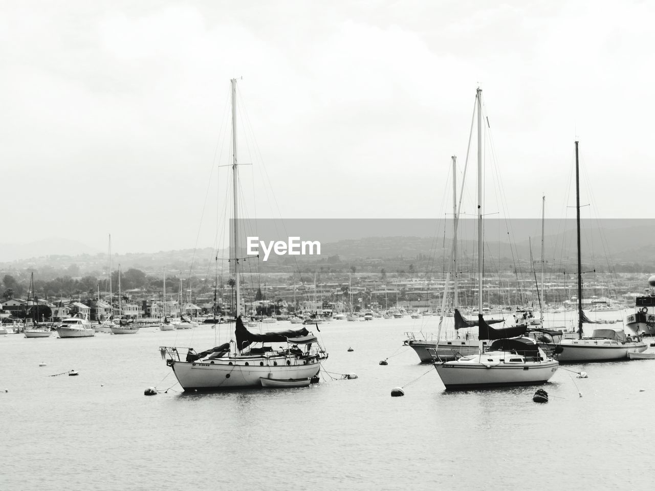 Sailboat moored on sea against sky