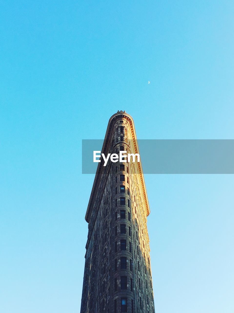 Low angle view of flatiron building against clear sky