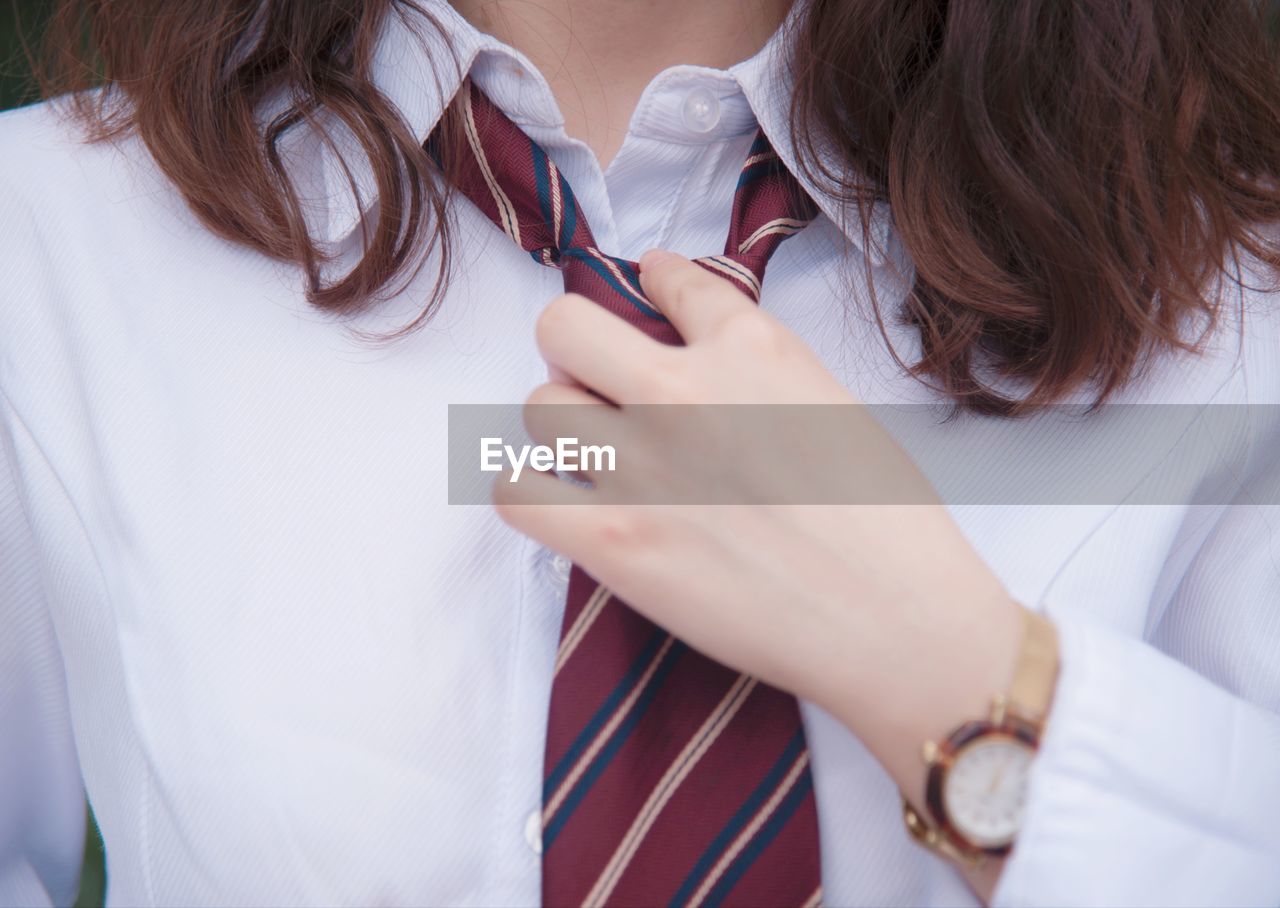 Midsection of woman wearing tie