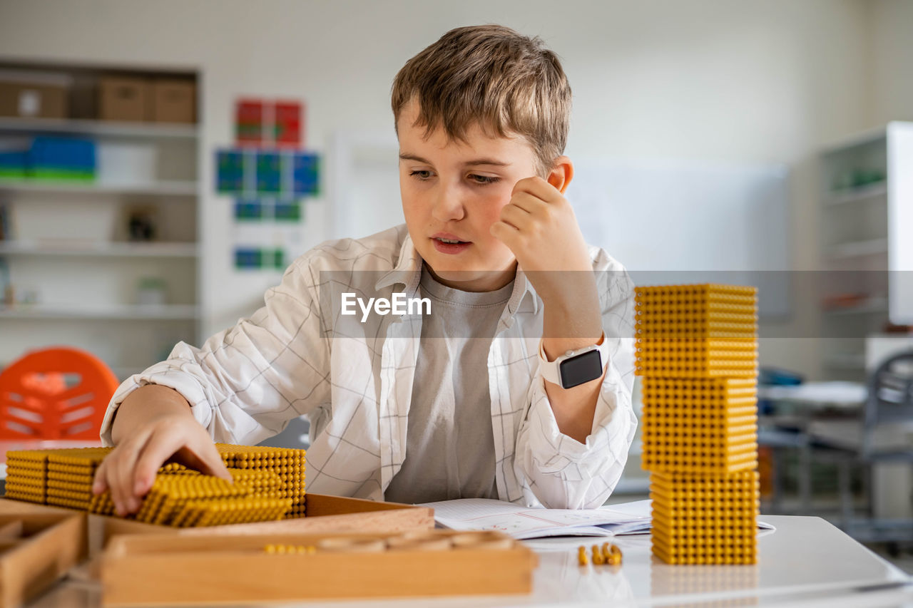 young man using laptop on table in office