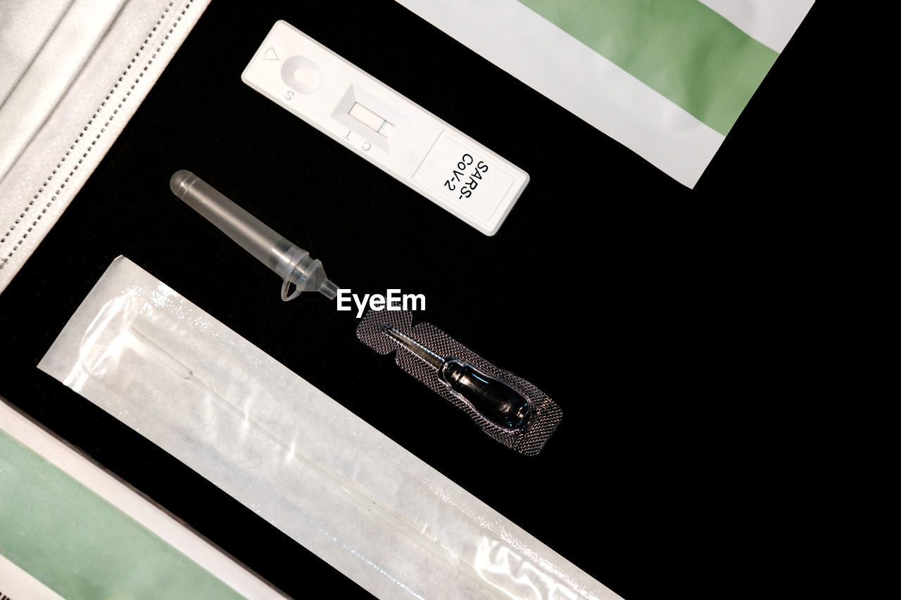 Flat lay picture of a negative antigen test on black background.  covid 19 self test . 