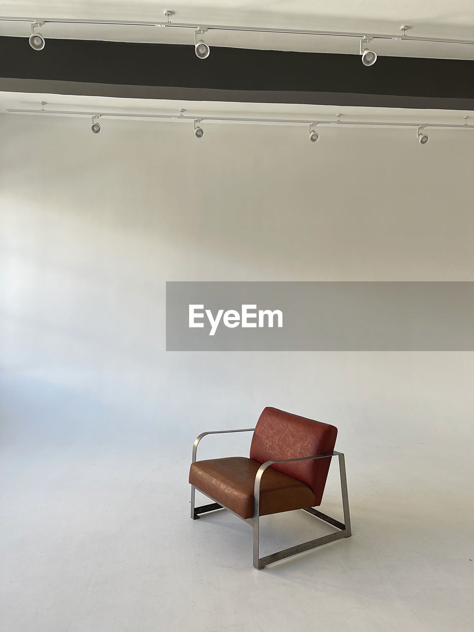 EMPTY CHAIRS ON TABLE AGAINST WALL AT HOME