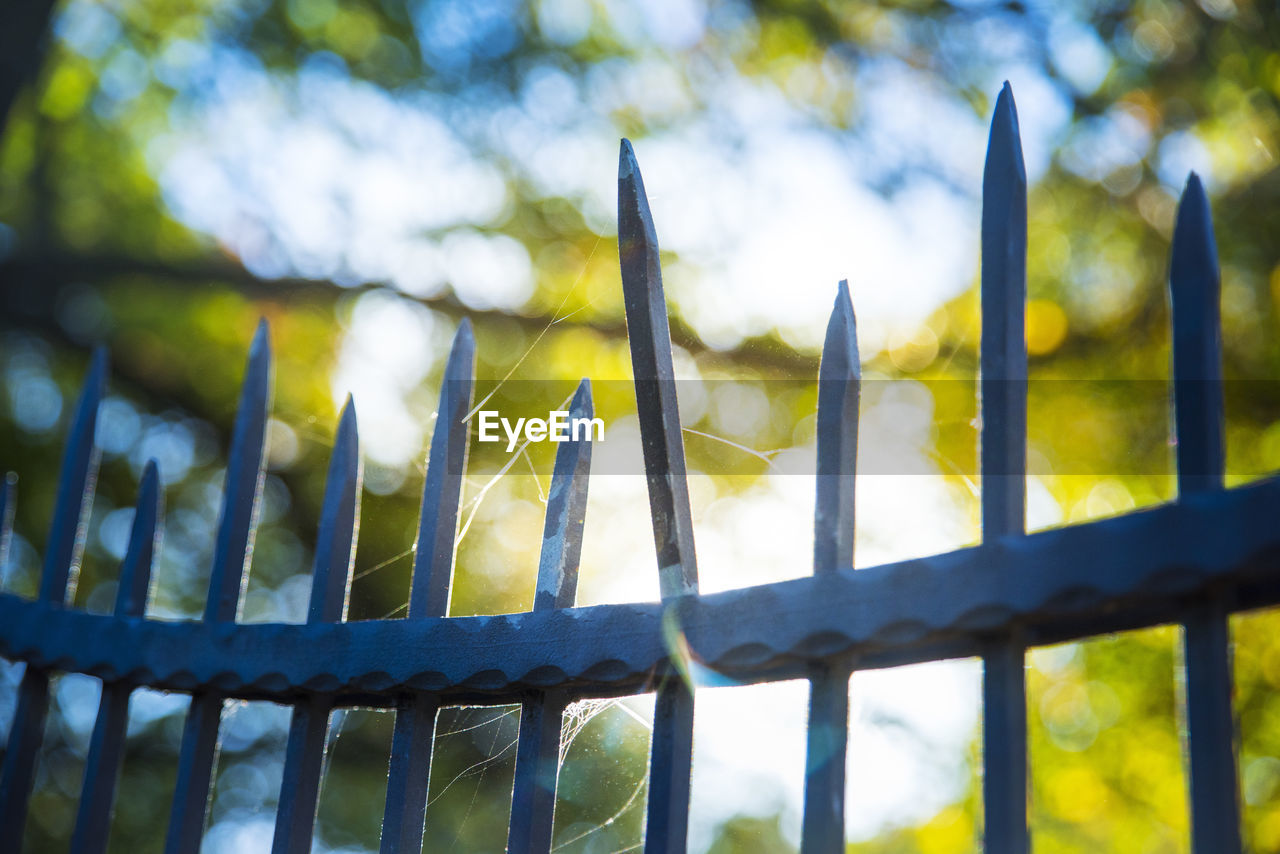 CLOSE-UP OF FENCE BY RAILING