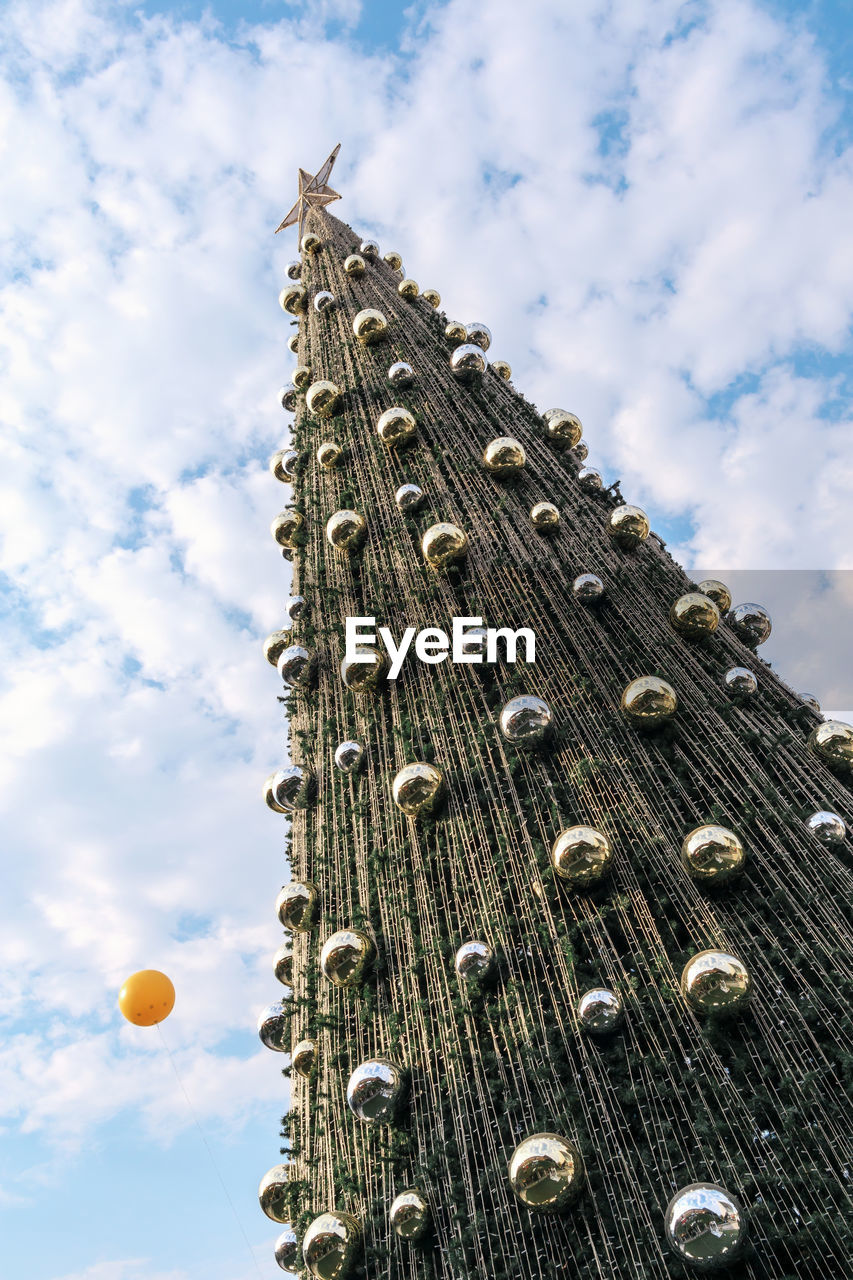 Outdoor christmas tree at daytime with beautiful blue sky