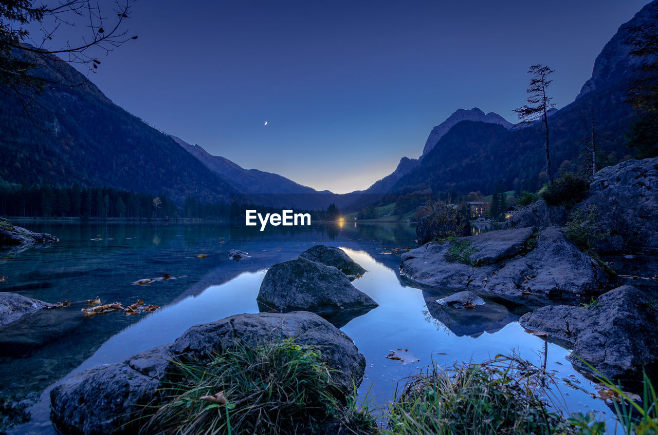 Panoramic view of lake and mountains against sky at dusk