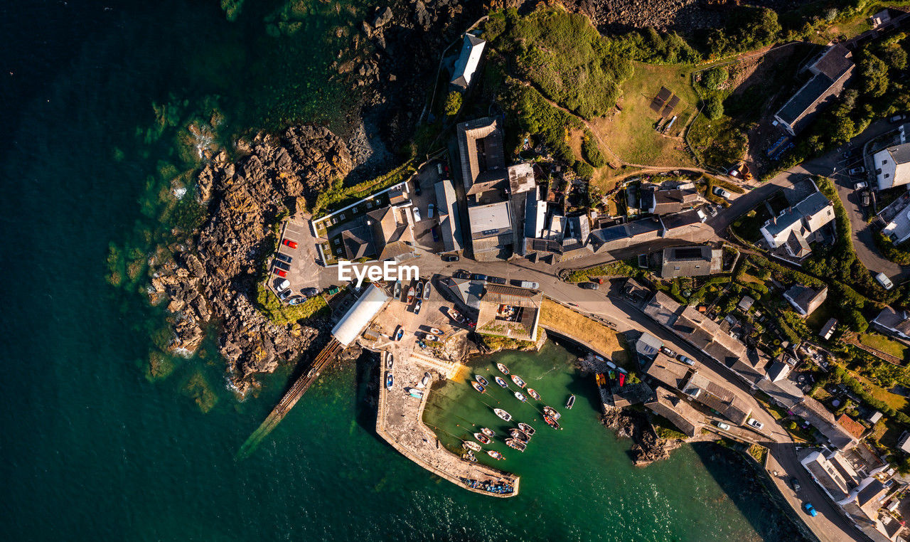 Aerial above the cornish fishing village of coverack cornwall on rocky outcrop of land with harbour