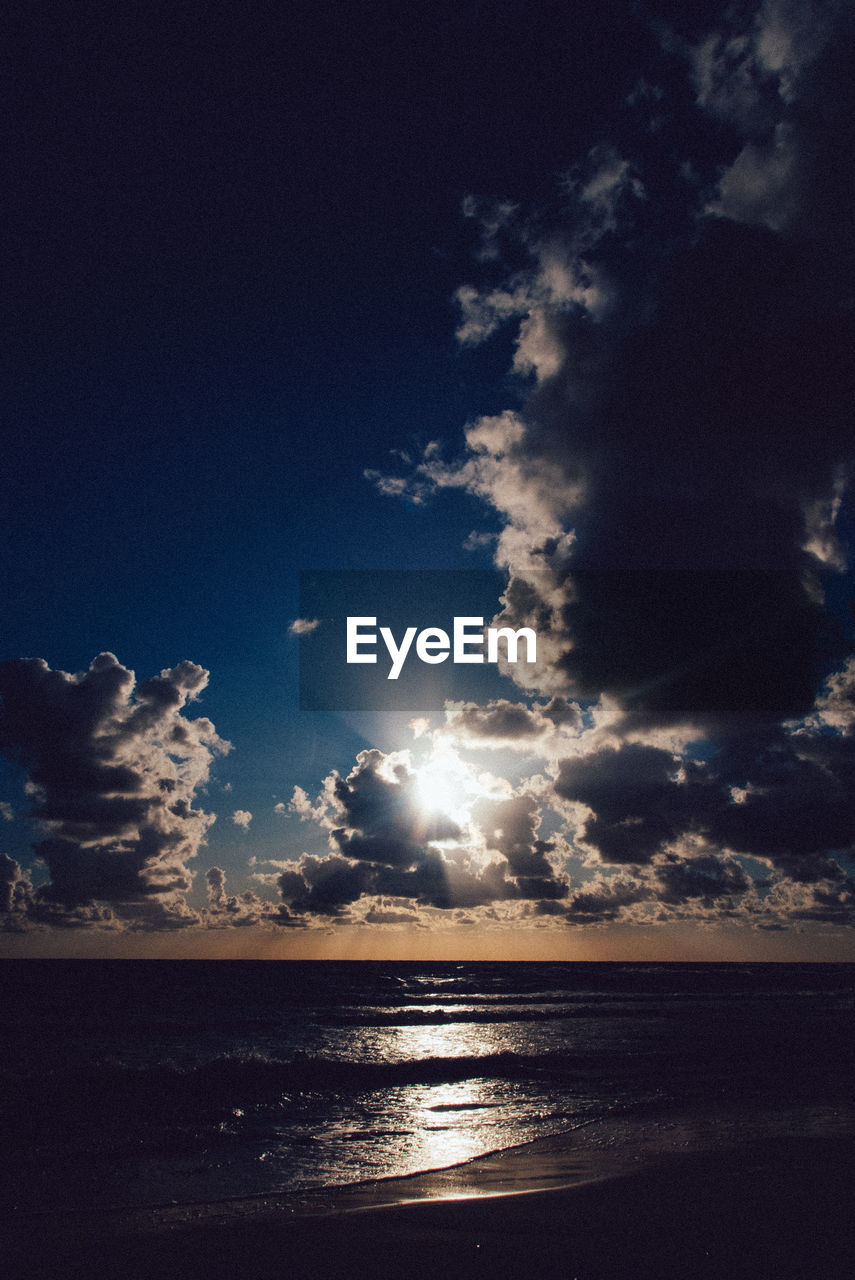 SCENIC VIEW OF BEACH AGAINST SKY DURING SUNSET