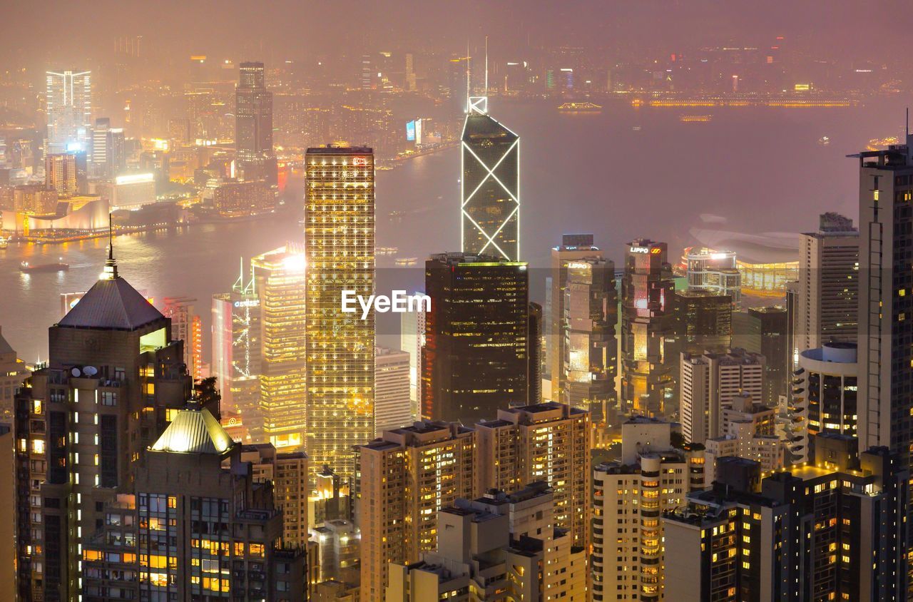 ILLUMINATED BUILDINGS AGAINST SKY AT NIGHT