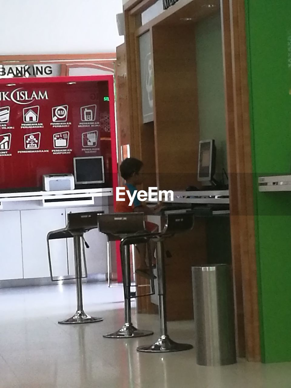 REFLECTION OF MAN ON TABLE IN ROOM