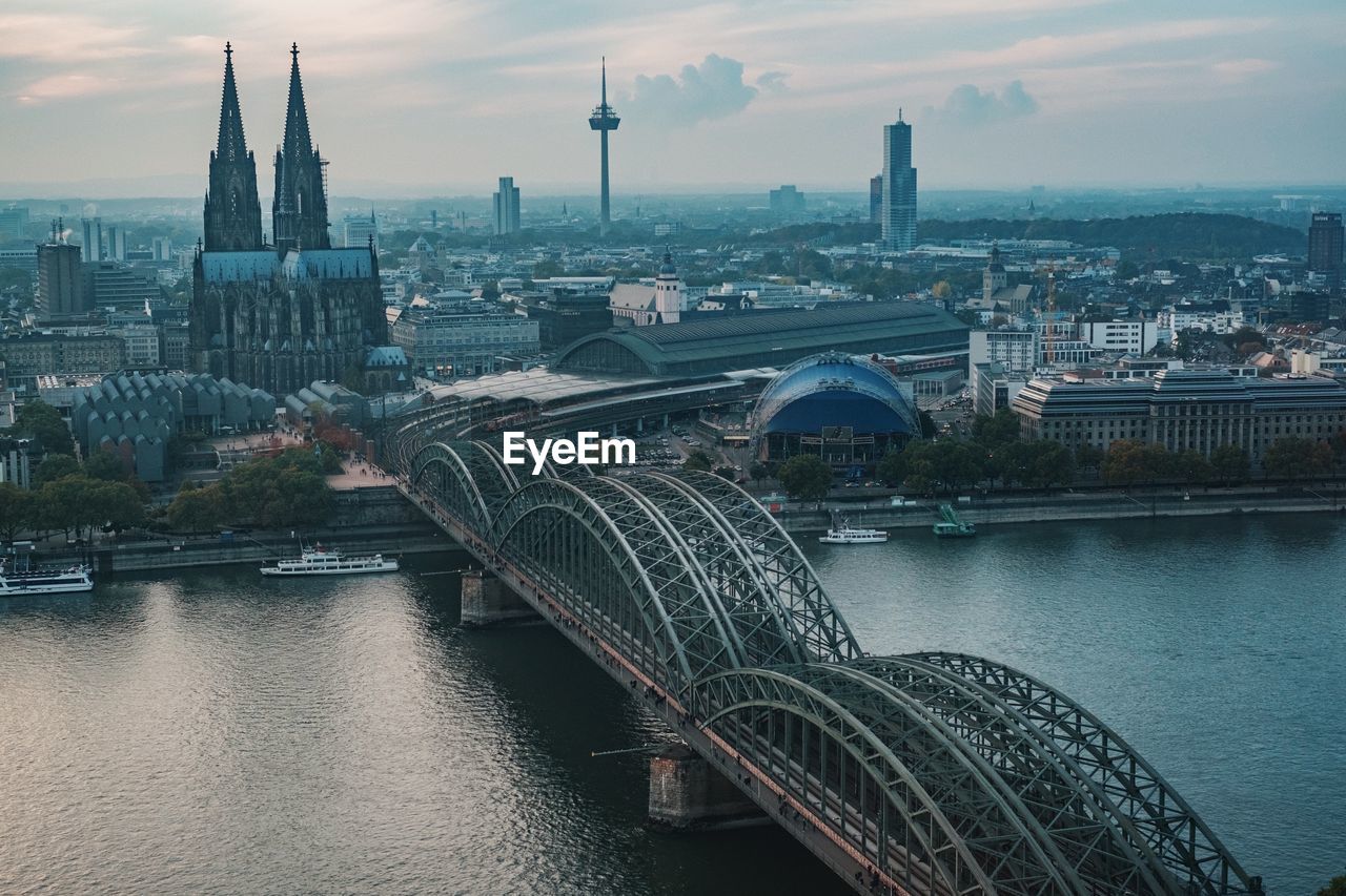 Bridge over river with city in background