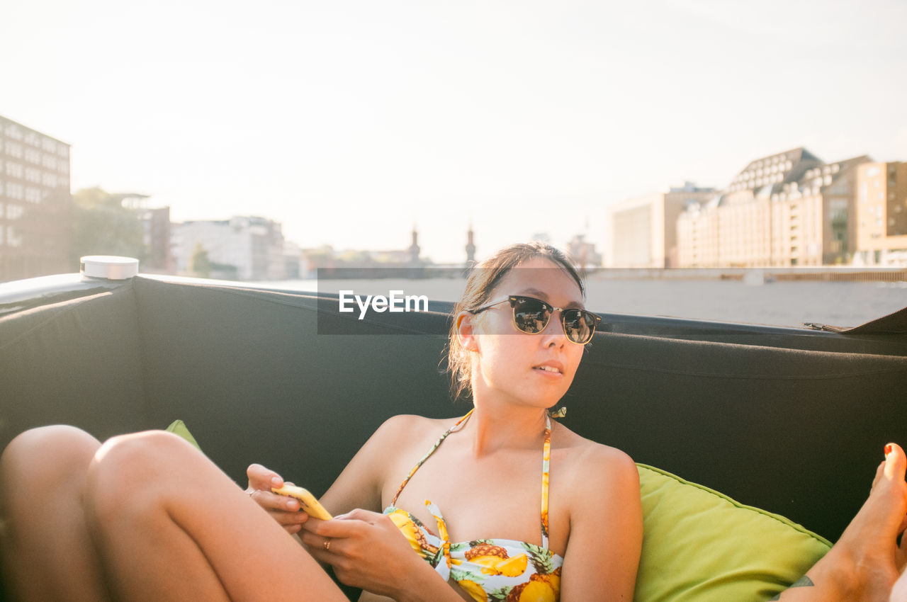 Woman sitting and enjoying in boat at river