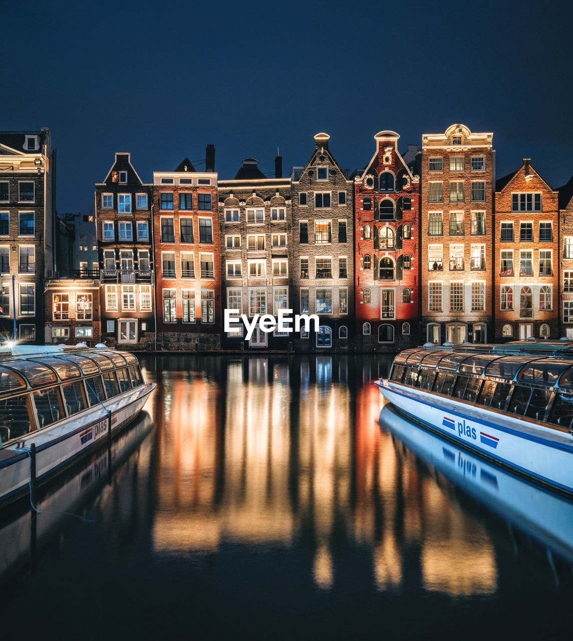 CANAL AMIDST BUILDINGS AGAINST CLEAR SKY