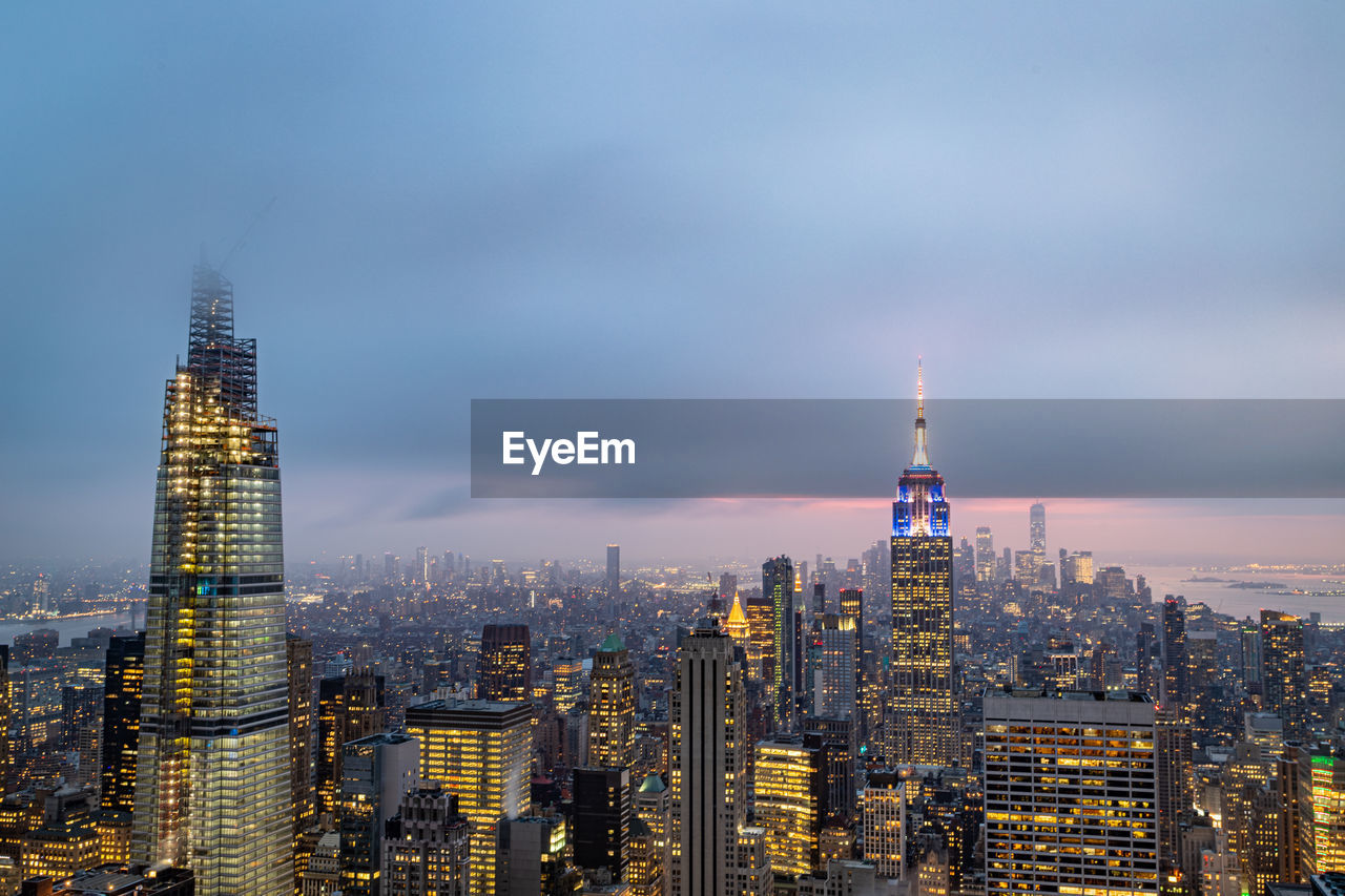 New york skyline from the top of the rock  in rockefeller center at night with clouds in the sky