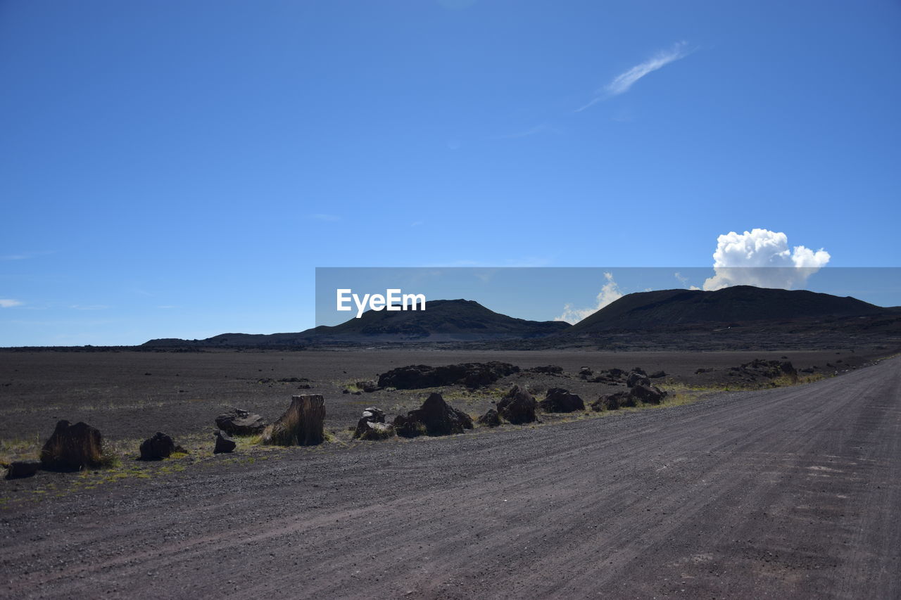 Scenic view of desert road against sky