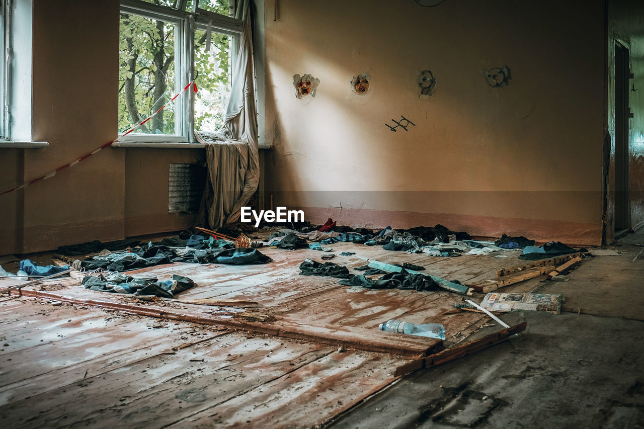 - ukraine summer 2022 - shelled school. clothes lying on the floor