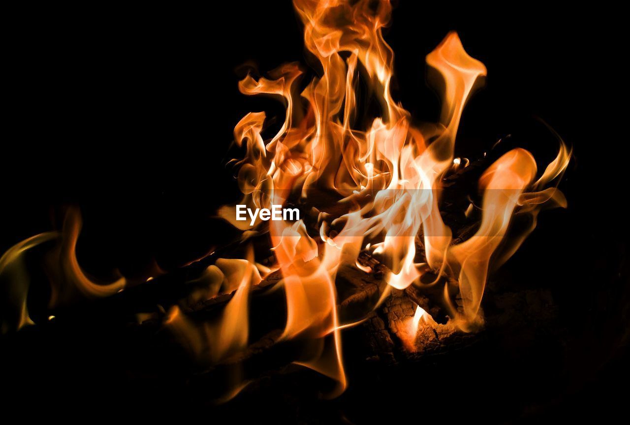 CLOSE-UP OF BURNING FIRE IN THE DARK