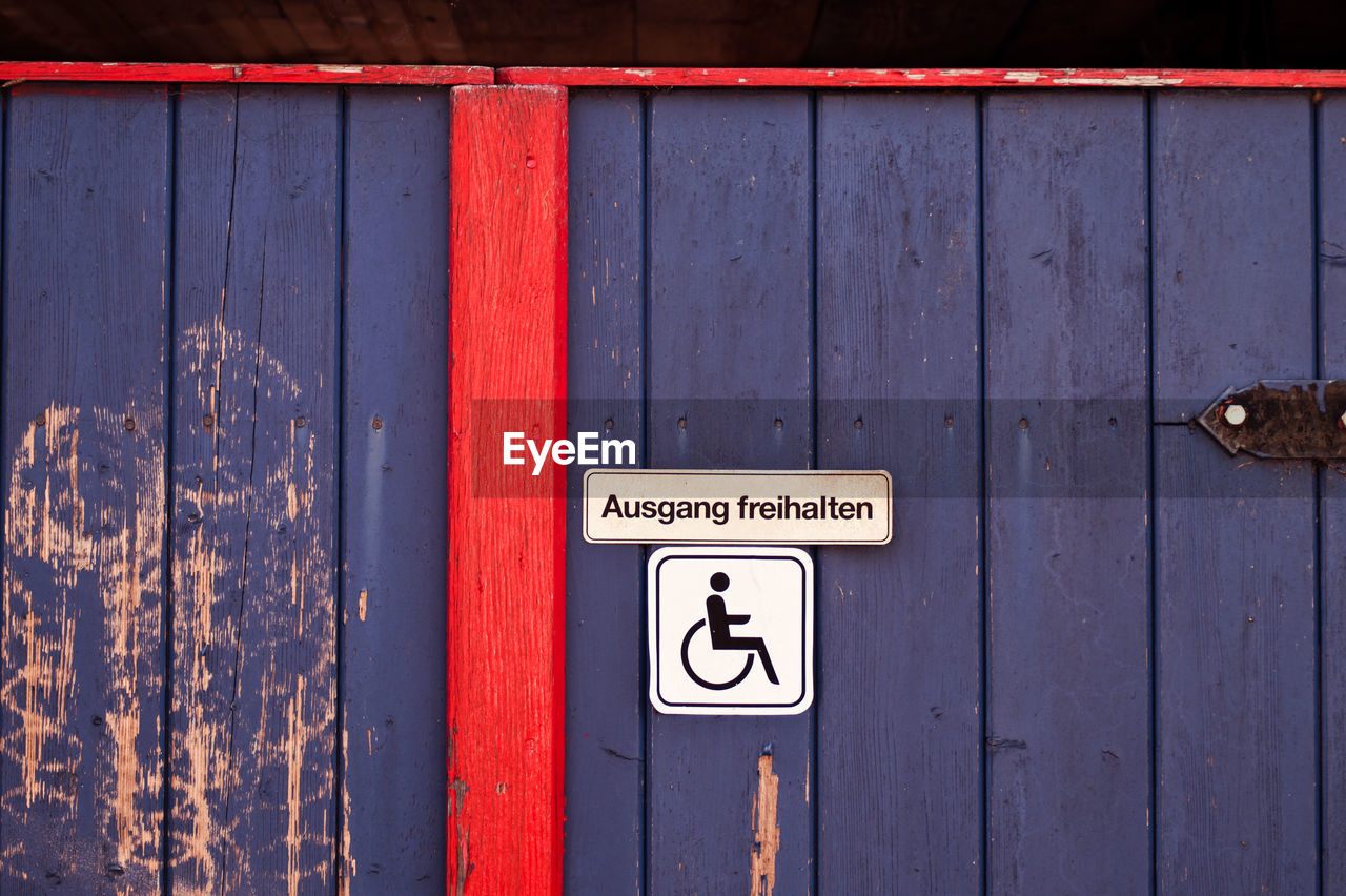 Disabled sign on wooden door