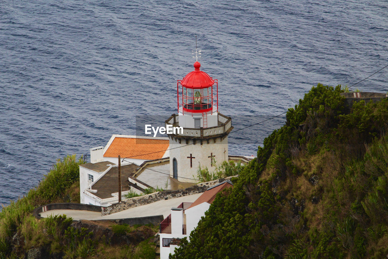 High angle view of red lighthouse by sea