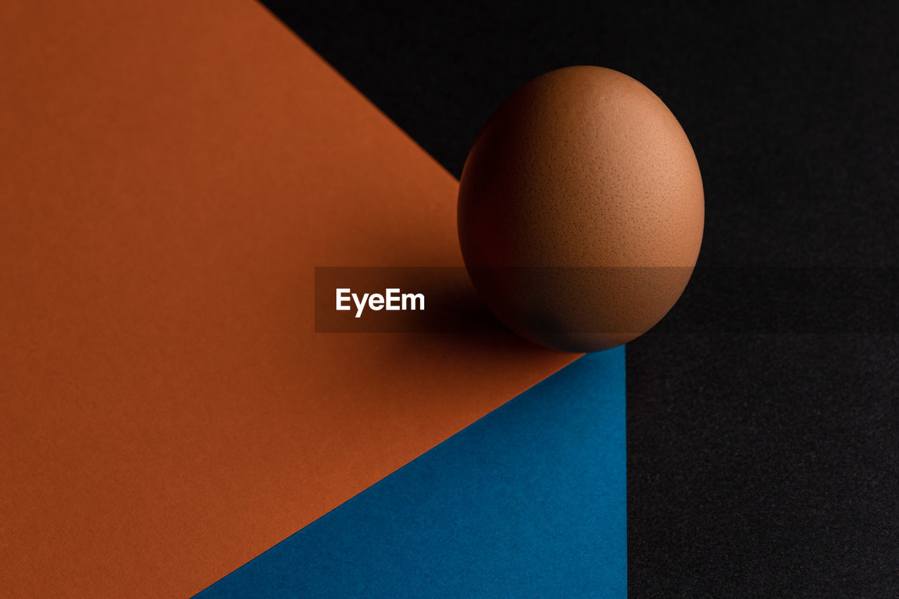 High angle view of egg on table against black background
