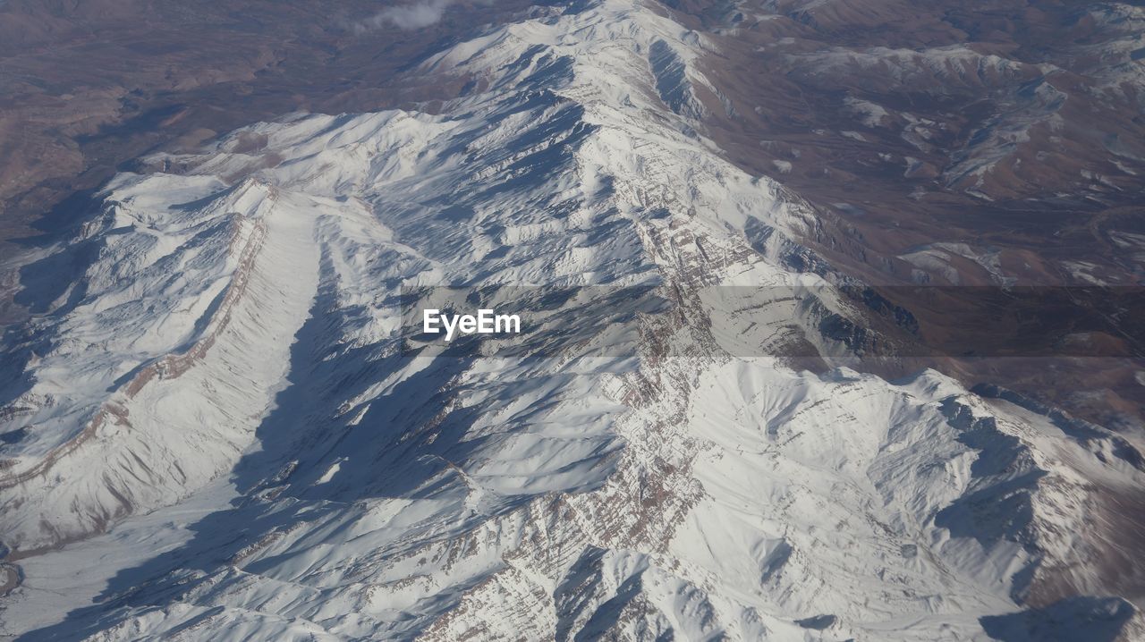 HIGH ANGLE VIEW OF SNOW COVERED MOUNTAIN