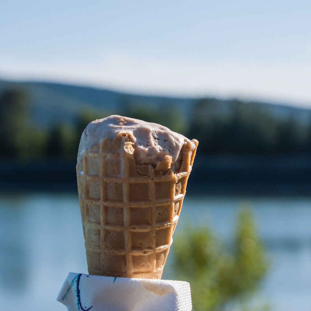 Close-up of ice cream waffle cone against sky