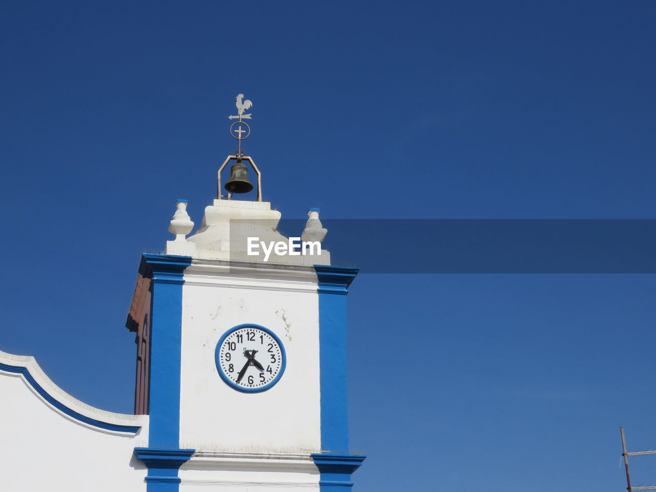 Low angle view of clock tower against blue sky